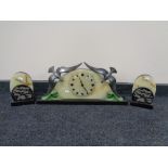 An Art Deco three piece clock garniture with onyx and polished slate decoration