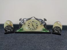 An Art Deco three piece clock garniture with onyx and polished slate decoration