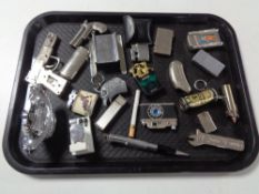 A tray of a quantity of table lighters etc