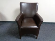 A stitched brown leather armchair