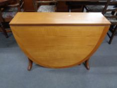 A mid century teak flap sided dining table