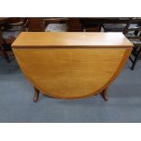 A mid century teak flap sided dining table