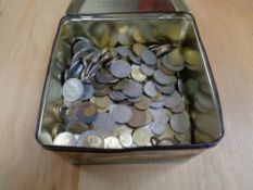 A tin of world coins