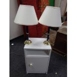 A modern white bedside cabinet and pair of lamps