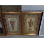 A pair of gilt framed pictures depicting urns