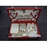 A mid century picnic set in red travel case
