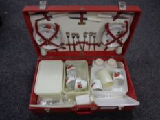 A mid century picnic set in red travel case