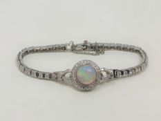 A 14ct white gold opal and diamond bracelet, the Australian cabochon opal weighing 3.