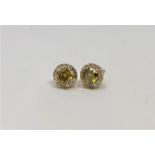 A pair of 14ct gold yellow diamond stud earrings,