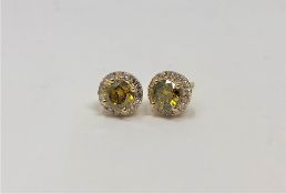 A pair of 14ct gold yellow diamond stud earrings,