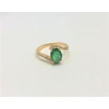 A 14ct yellow gold emerald and diamond ring, featuring centre oval cut emerald (1.