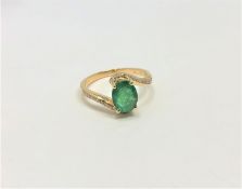 A 14ct yellow gold emerald and diamond ring, featuring centre oval cut emerald (1.