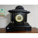 A nineteenth century black slate and gilt highlighted mantel clock