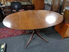 An oval inlaid mahogany pedestal dining table