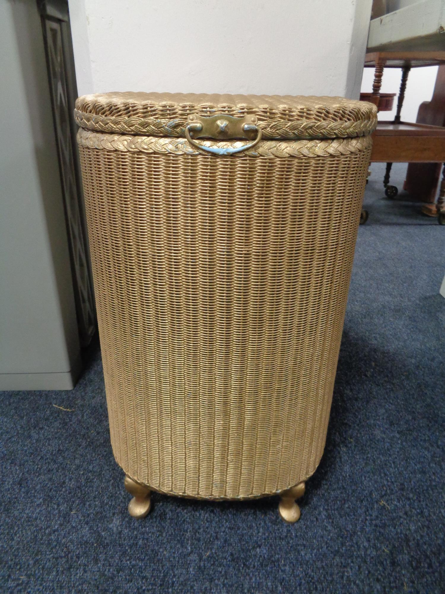 A golden Lloyd loom linen basket