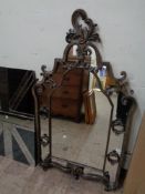 An antique style metal framed mirror