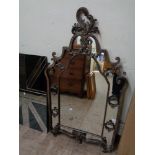 An antique style metal framed mirror