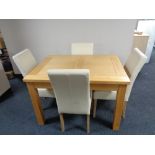 A contemporary light oak extending dining table with four cream leather chairs CONDITION