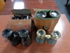 A box of four pairs of antique field glasses