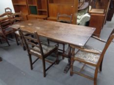 An oak refectory dining table together with six ladder backed chairs