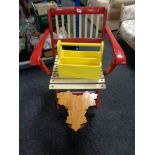 A vintage folding chair together with a wooden plant stand