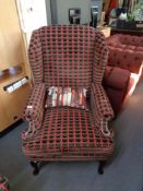 An antique style armchair upholstered in symmetrical fabric