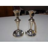 A pair of small silver candlesticks, Birmingham A L Davenport, 1955, height 14 cm.