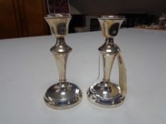 A pair of small silver candlesticks, Birmingham A L Davenport, 1955, height 14 cm.