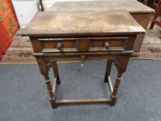 A nineteenth century style oak two drawer side table