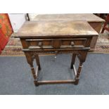 A nineteenth century style oak two drawer side table