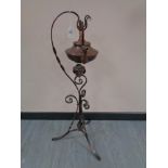 An Arts and Crafts copper spirit kettle with burner on stand, height 88 cm.