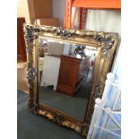 An antique style gilt framed bevelled mirror