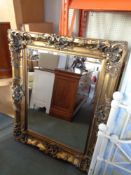 An antique style gilt framed bevelled mirror