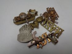 A small quantity of military lapel and cap badges etc