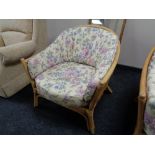 A two seater conservatory settee with armchair