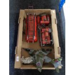 Two tin plate models of fire engines and another of a fighter jet.