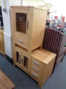 A beech entertainment unit fitted with drawers together with an audio cabinet