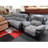 A reclining cloth and black leather three seater settee with matching armchair