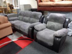 A reclining cloth and black leather three seater settee with matching armchair