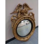 A Regency-style composition and carved giltwood convex wall mirror,