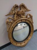 A Regency-style composition and carved giltwood convex wall mirror,