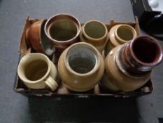 A box of stoneware storage jars,