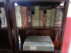 A collection of decorative items, false books, storage box, ceramic horse figures,