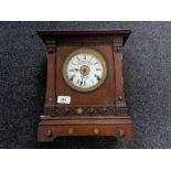 An Edwardian oak cased mantel clock with silvered and enamelled dial by Fattorini and Sons,