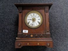 An Edwardian oak cased mantel clock with silvered and enamelled dial by Fattorini and Sons,