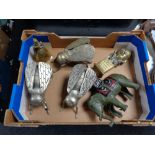 Three metal fly ornaments together with a cast elephant figure,