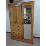 A late nineteenth century compaction wardrobe with mirrored door