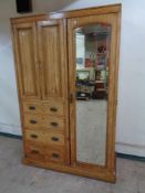 A late nineteenth century compaction wardrobe with mirrored door