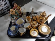 A tray of Continental ornaments, gilded china miniature coffee set,