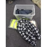 A crate of new and un-used clothing, thermal outdoor trousers,